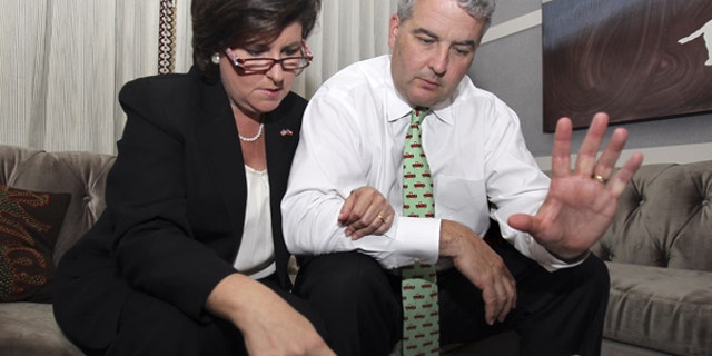 Aug. 10: Georgia gubernatorial candidate Karen Handel and her husband Steve Handel look over early returns after the polls closed Tuesday night in Atlanta.