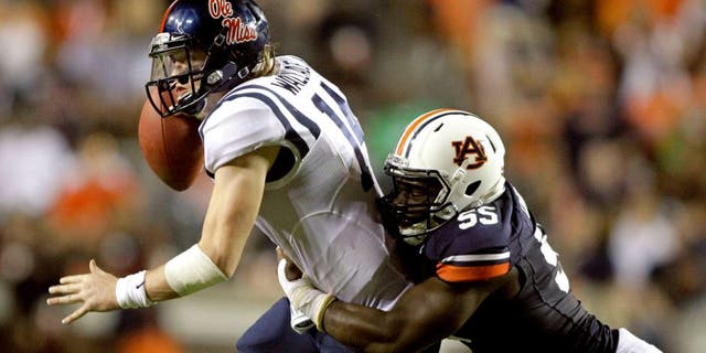Oct 5, 2013; Auburn, AL, USA; Mississippi Rebels quarterback Bo Wallace (14) is tackled by Auburn Tigers defensive end Carl Lawson (55) during the first half at Jordan Hare Stadium. Mandatory Credit: John Reed-USA TODAY Sports