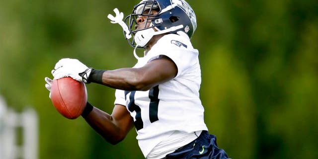 Jul 25, 2014; Renton, WA, USA; Seattle Seahawks free safety Dion Bailey (37) intercepts a pass during training camp practice at the Virginia Mason Athletic Center. Mandatory Credit: Joe Nicholson-USA TODAY Sports