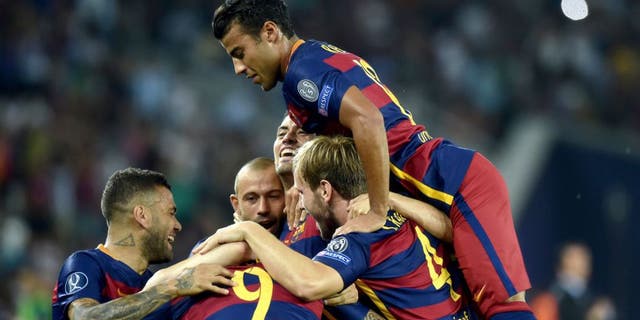 Barcelona's players celebrate after scoring a goal during the UEFA Super Cup final football match between FC Barcelona and Sevilla FC in Tbilisi on August 11, 2015. AFP PHOTO/KIRILL KUDRYAVTSEV (Photo credit should read KIRILL KUDRYAVTSEV/AFP/Getty Images)