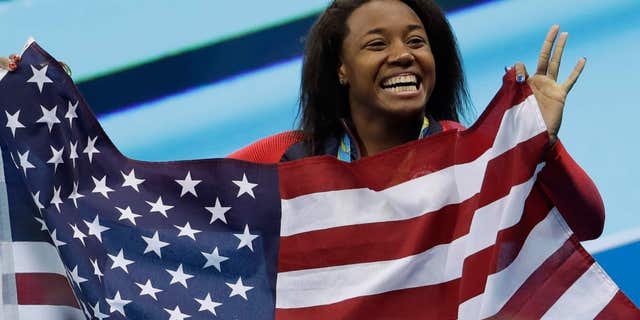 United States' Simone Manuel celebrates winning the gold medal in the women's 100-meter freestyle during the swimming competitions at the 2016 Summer Olympics, Friday, Aug. 12, 2016, in Rio de Janeiro, Brazil.