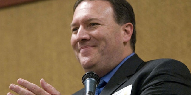 In this Jan. 26, 2008 file photo Mike Pompeo applauds the crowd at the Kansas Republican State Committee for their support in Topeka, Kan. Pompeo has apologized for his campaign's online links to a blog that used an ethnic slur to describe his Democratic opponent.