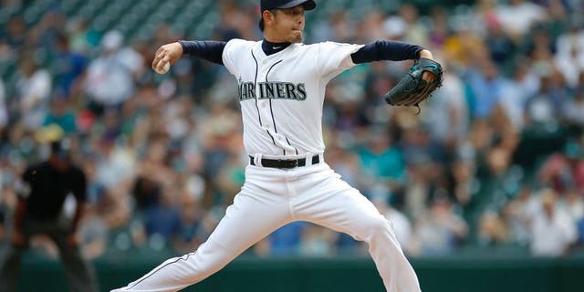 SEATTLE, WA - AUGUST 12: Starting pitcher Hisashi Iwakuma #18 of the Seattle Mariners pitches against the Baltimore Orioles in the first inning at Safeco Field on August 12, 2015 in Seattle, Washington. (Photo by Otto Greule Jr/Getty Images)