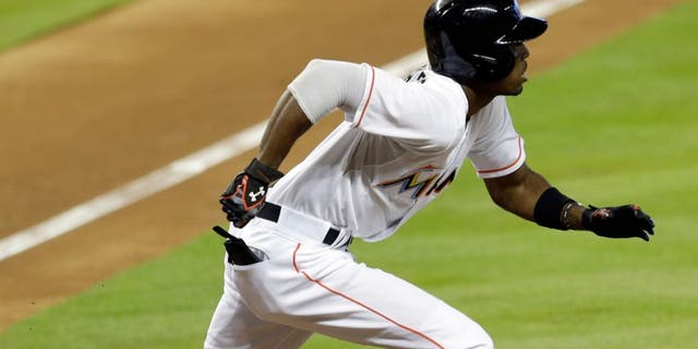Miami Marlins' Dee Gordon heads to first base after hitting a solo home run against the Boston Red Sox during the first inning of a baseball game, Wednesday, Aug. 12, 2015, in Miami. (AP Photo/Alan Diaz)