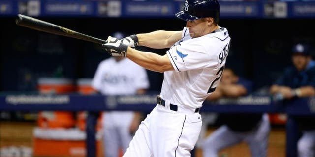 Aug 12, 2015; St. Petersburg, FL, USA; Tampa Bay Rays left fielder Grady Sizemore (24) singles during the third inning against the Atlanta Braves at Tropicana Field. Mandatory Credit: Kim Klement-USA TODAY Sports