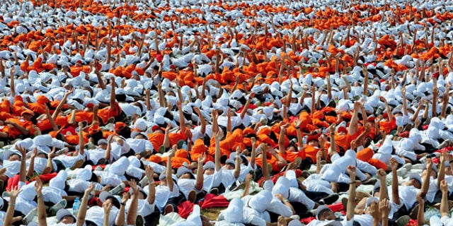 Aug. 12: In an attempt to enter the Guinness Book of World Records, 10,267 people acted as human dominoes, tumbling in less than two hours in Ordos, Inner Mongolia.