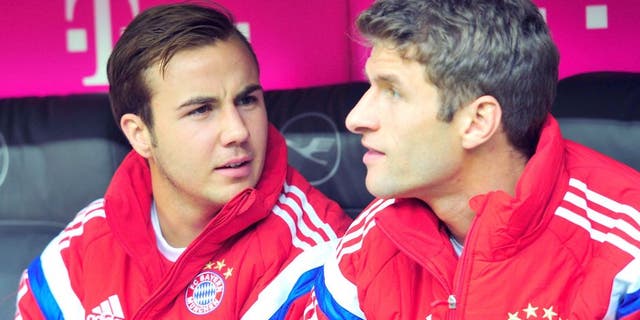 MUNICH, GERMANY - OCTOBER 04: Mario Goetze (L) and Thomas Mueller of Muenchen look on as they sit on the bench prior to the Bundesliga match between FC Bayern Muenchen and Hannover 96 at Allianz Arena on October 4, 2014 in Munich, Germany. (Photo by Lennart Preiss/Bongarts/Getty Images)