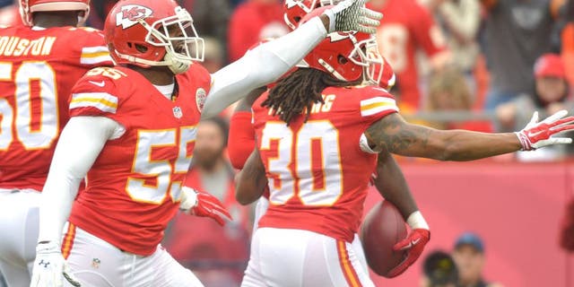 Dec 14, 2014; Kansas City, MO, USA; Kansas City Chiefs linebacker Dee Ford (55) and outside linebacker Justin Houston (50) celebrate after a play during the first half against the Oakland Raiders at Arrowhead Stadium. The Chiefs won 31-13. Mandatory Credit: Denny Medley-USA TODAY Sports