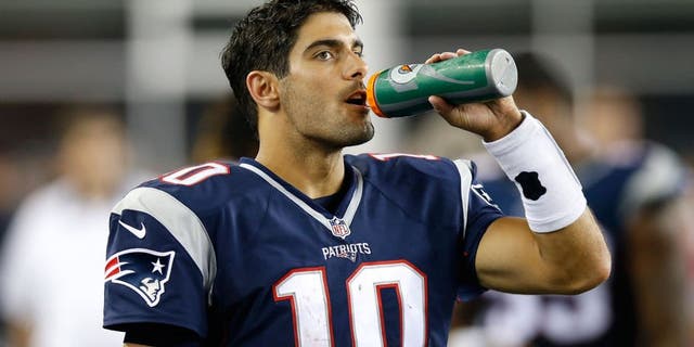 Aug 13, 2015; Foxborough, MA, USA; New England Patriots quarterback Jimmy Garoppolo (10) drinks some water on the side line during the third quarter against the Green Bay Packers at Gillette Stadium. The Green Bay Packers won 22-11. Mandatory Credit: Greg M. Cooper-USA TODAY Sports