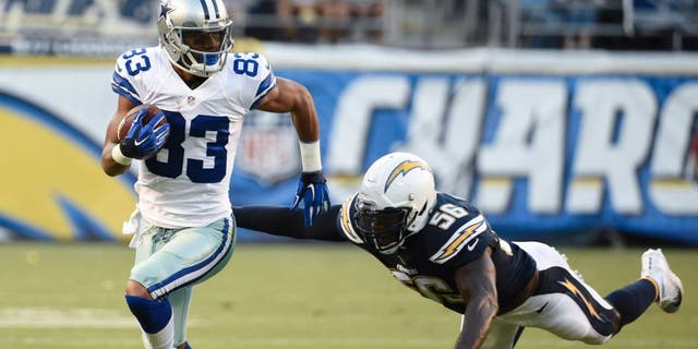 Dallas Cowboys wide receiver Terrance Williams runs upfield after a completion as San Diego Chargers inside linebacker Donald Butler defends during the first half of an NFL preseason football game Thursday, Aug. 13, 2015 in San Diego. (AP Photo/Denis Poroy)