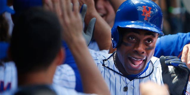 Aug 13, 2015; New York City, NY, USA; New York Mets right fielder Curtis Granderson (3) is congratulated in the dugout by teammates after his two run home run in the fourth inning against the Colorado Rockies at Citi Field. Mandatory Credit: Noah K. Murray-USA TODAY Sports