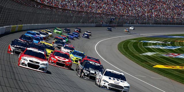 BROOKLYN, MI - JUNE 15: Kevin Harvick, driver of the #4 Budweiser Chevrolet, and Brad Keselowski, driver of the #2 Miller Lite Ford, lead the field on a restart during the NASCAR Sprint Cup Series Quicken Loans 400 at Michigan International Speedway on June 15, 2014 in Brooklyn, Michigan. (Photo by Brian Lawdermilk/NASCAR via Getty Images)