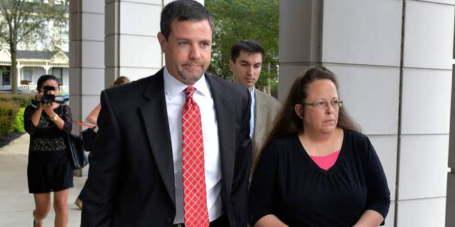 July 20, 2015: Rowan County Clerk Kim Davis, right, walks with her attorney Roger Gannam into the United States District Court for the Eastern District of Kentucky in Covington, Ky.