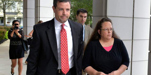 July 20, 2015: Rowan County Clerk Kim Davis, right, walks with her attorney Roger Gannam into the United States District Court for the Eastern District of Kentucky in Covington, Ky.