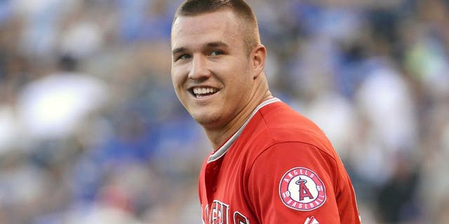 Aug 13, 2015; Kansas City, MO, USA; Los Angeles Angels center fielder Mike Trout (27) walks to the outfield in the first inning against the Kansas City Royals at Kauffman Stadium. Mandatory Credit: John Rieger-USA TODAY Sports