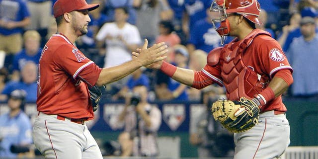 Aug 13, 2015; Kansas City, MO, USA; Los Angeles Angels relief pitcher Huston Street (16) celebrates with catcher Carlos Perez (58) after the game against the Kansas City Royals at Kauffman Stadium. The Angels won the game 7-6. Mandatory Credit: John Rieger-USA TODAY Sports