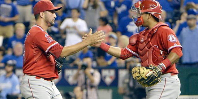 Aug 13, 2015; Kansas City, MO, USA; Los Angeles Angels relief pitcher Huston Street (16) celebrates with catcher Carlos Perez (58) after the game against the Kansas City Royals at Kauffman Stadium. The Angels won the game 7-6. Mandatory Credit: John Rieger-USA TODAY Sports