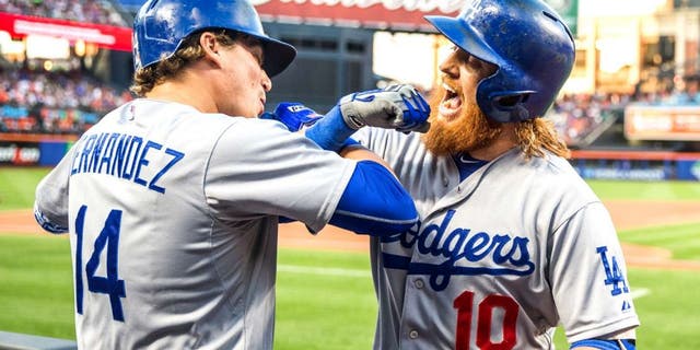 NEW YORK - JULY 24: Justin Turner #10 of the Los Angeles Dodgers fist bumps Enrique Hernandez #14 after hitting a home run during the game against the New York Mets at Citi Field on July 24, 2015 in the Queens borough of New York City. (Photo by Rob Tringali/SportsChrome/Getty Images)