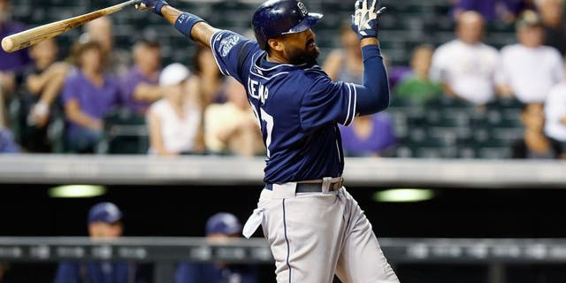 San Diego Padres' Matt Kemp watches his RBI triple off Colorado Rockies relief pitcher Justin Miller during the ninth inning of a baseball game Friday, Aug. 14, 2015, in Denver. With the triple, Kemp hit for the cycle as San Diego won 9-5. (AP Photo/David Zalubowski)