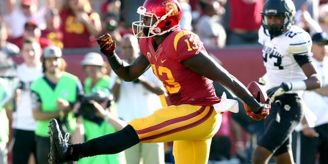 LOS ANGELES, CA - OCTOBER 18: Tight end Bryce Dixon #13 of the USC Trojans high steps in the end zone after scoring on a nine yard touchdown pass play in the second quarter against the Colorado Buffaloes at Los Angeles Memorial Coliseum on October 18, 2014 in Los Angeles, California. (Photo by Stephen Dunn/Getty Images)