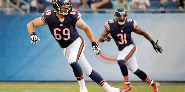Aug 13, 2015; Chicago, IL, USA; Chicago Bears linebacker Jared Allen (69) and defensive back Antrel Rolle (31) follow the play during the first quarter against the Miami Dolphins in a preseason NFL football game at Soldier Field. Mandatory Credit: Jon Durr-USA TODAY Sports
