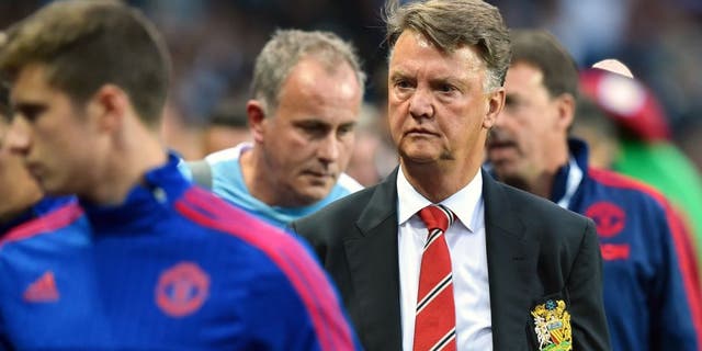 Manchester United's Dutch manager Louis van Gaal (2nd R) arrives for the start of the English Premier League football match between Aston Villa and Manchester United at Villa Park in Birmingham, central England, on August 14, 2015. AFP PHOTO / BEN STANSALL RESTRICTED TO EDITORIAL USE. No use with unauthorized audio, video, data, fixture lists, club/league logos or 'live' services. Online in-match use limited to 75 images, no video emulation. No use in betting, games or single club/league/player publications. (Photo credit should read BEN STANSALL/AFP/Getty Images)