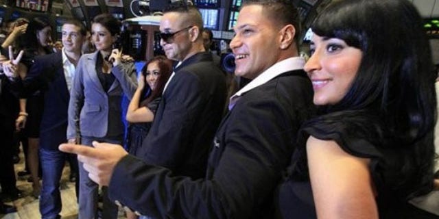 July 27: Cast members of MTV's "Jersey Shore" reality series pose for photos after ringing the opening bell of the New York Stock Exchange. They are, from left: Vinny Guadagnino; Jenni "J-Woww" Farley; Nicole "Snooki" Polizzi; Michael "The Situation" Sorrentino; Ronnie Ortiz; Angelina "Jolie" Pivarnick. (AP Photo/Richard Drew)