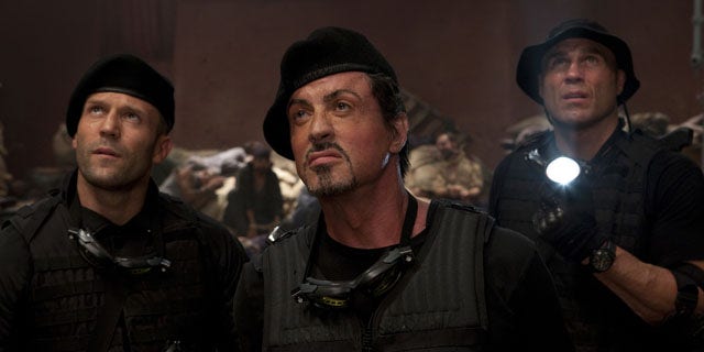 In this film publicity image released by Lionsgate Entertainment, from left, Jason Statham, Sylvester Stallone and Randy Couture are shown in a scene from "The Expendables."