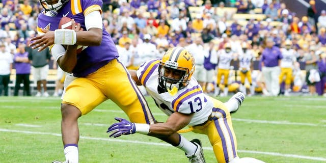 Apr 5, 2014; Baton Rouge, LA, USA; LSU Tigers quarterback Brandon Harris (6) runs for a touchdown past cornerback Dwayne Thomas (13) during the 2014 spring game at Tiger Stadium. Mandatory Credit: Derick E. Hingle-USA TODAY Sports