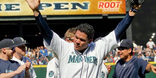SEATTLE, WA - AUGUST 15: Starting pitcher Felix Hernandez #34 of the Seattle Mariners celebrates with teammates after throwing a perfect game to defeat the Tampa Bay Rays 1-0 at Safeco Field on August 15, 2012 in Seattle, Washington. It was the 23rd perfect game in Major League Baseball history. (Photo by Otto Greule Jr/Getty Images)
