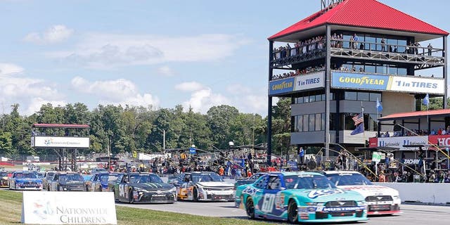 LEXINGTON, OH - AUGUST 15: Chris Buescher, driver of the #60 Zest Ford, and Alex Tagliani, driver of the #22 Discount Tire Ford, lead the field through the start/finish line for the start of the NASCAR Xfinity Nationwide Children's Hospital 200 at Mid-Ohio Sports Car Course on August 15, 2015 in Lexington, Ohio. Photo by Kirk Irwin/Getty Images)