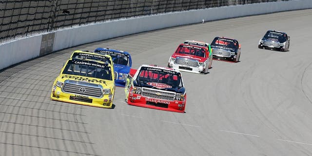 BROOKLYN, MI - AUGUST 15: Kyle Busch, driver of the #51 Dollar General Toyota, races Austin Dillon, driver of the #33 Rheem/Young Supply Company Chevrolet, during the NASCAR Camping World Truck Series Careers for Veterans 200 at Michigan International Speedway on August 15, 2015 in Brooklyn, Michigan. (Photo by Nick Laham/NASCAR via Getty Images)
