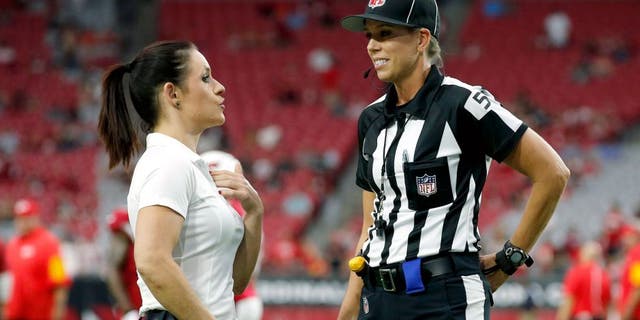 Arizona Cardinals training camp assistant linebackers coach Jen Welter, left, talks with line judge Sarah Thomas prior to an NFL preseason football game between the Cardinals and the Kansas City Chiefs on Saturday, Aug. 15, 2015, in Glendale, Ariz. (AP Photo/Ross D. Franklin)