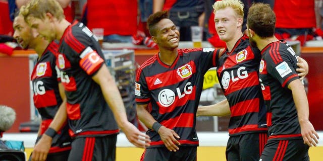 Leverkusen's midfielder Julian Brandt (2nd R) celebrates with Leverkusen's Swiss forward Admir Mehmedi (R) and Leverkusen's Brazilian defender Wendell after scoring 2-1 during the German first division Bundesliga football match Bayer 04 Leverkusen vs TSG 1899 Hoffenheim in Leverkusen, western Germany, on August 15, 2015. AFP PHOTO / SASCHA SCHUERMANN RESTRICTIONS: DURING MATCH TIME: DFL RULES TO LIMIT THE ONLINE USAGE TO 15 PICTURES PER MATCH AND FORBID IMAGE SEQUENCES TO SIMULATE VIDEO. == RESTRICTED TO EDITORIAL USE == FOR FURTHER QUERIES PLEASE CONTACT DFL DIRECTLY AT + 49 69 650050. (Photo credit should read SASCHA SCHUERMANN/AFP/Getty Images)