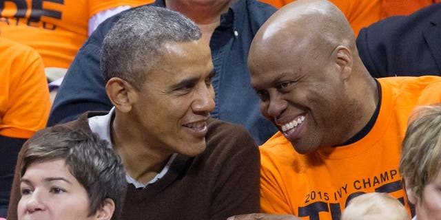 Barack Obama (L) sits beside his brother-in-law Craig Robinson while attending the Green Bay versus Princeton women's college basketball game  (Photo by MIchael Reynolds-Pool/Getty Images)