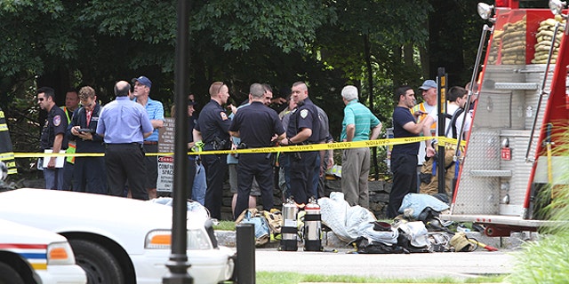 June 18: Various police and fire agencies work at the nearby wreckage site of a small plane crash in Armonk, N.Y.
