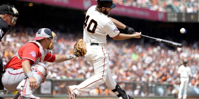 San Francisco Giants' Madison Bumgarner (40) swings for a home run off Washington Nationals' Casey Janssen in the seventh inning of a baseball game Sunday, Aug. 16, 2015, in San Francisco. (AP Photo/Ben Margot)