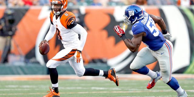New York Giants defensive end Owamagbe Odighizuwa (58) chases Cincinnati Bengals quarterback Josh Johnson during the first half of an NFL preseason football game in Cincinnati, Friday, Aug. 14, 2015. (AP Photo/Gary Landers)