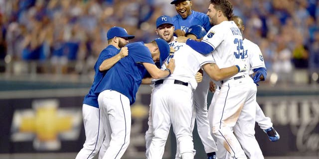 Aug 16, 2015; Kansas City, MO, USA; Kansas City Royals players celebrate after Kendrys Morales (center) hit a walk off single against the Los Angeles Angels during the tenth inning at Kauffman Stadium. Mandatory Credit: Peter G. Aiken-USA TODAY Sports