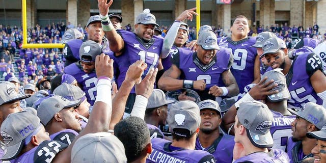 Dec 6, 2014; Fort Worth, TX, USA; TCU Horned Frogs quarterback Trevone Boykin (2) and safety Sam Carter (17) and teammates celebrate after the victory against the Iowa State Cyclones at Amon G. Carter Stadium. Mandatory Credit: Kevin Jairaj-USA TODAY Sports