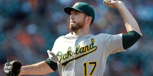 Aug 16, 2015; Baltimore, MD, USA; Oakland Athletics first baseman Ike Davis (17) pitches during the eighth inning against the Baltimore Orioles at Oriole Park at Camden Yards. The Orioles won 18-2. Mandatory Credit: Tommy Gilligan-USA TODAY Sports
