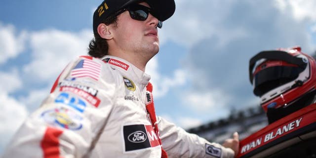 LONG POND, PA - JULY 29: Ryan Blaney, driver of the #21 Motorcraft/Quick Lane Tire & Auto Center Ford stands on the grid during qualifying for the NASCAR Sprint Cup Series Pennsylvania 400 at Pocono Raceway on July 29, 2016 in Long Pond, Pennsylvania. (Photo by Rainier Ehrhardt/NASCAR via Getty Images)