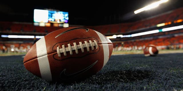 MIAMI GARDENS, FL - JANUARY 04: A detail of a Nike official NCAA size football as it sits in the end zone while the West Virginia Mountaineers stretchon the field prior to playing against the Clemson Tigers during the Discover Orange Bowl at Sun Life Stadium on January 4, 2012 in Miami Gardens, Florida. (Photo by Streeter Lecka/Getty Images)