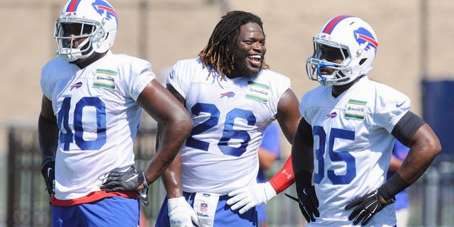 Jul 31, 2015; Pittsford, NY, USA; Buffalo Bills running back Anthony Dixon (26) speaks with Karlos Williams (40) and Bryce Brown (35) during training camp at St. John Fisher College. Mandatory Credit: Mark Konezny-USA TODAY Sports