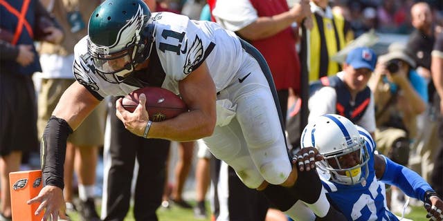 Aug 16, 2015; Philadelphia, PA, USA; Philadelphia Eagles quarterback Tim Tebow (11) dives into the end zone past Indianapolis Colts free safety Winston Guy (27) to score a touchdown during the second half of a preseason NFL football game at Lincoln Financial Field. The Eagles won 36-10. Mandatory Credit: Derik Hamilton-USA TODAY Sports