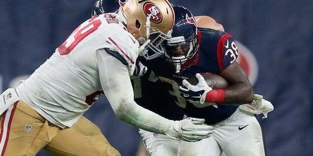 HOUSTON, TX - AUGUST 15: Kenny Hilliard #38 of the Houston Texans is tackled by Arik Armstead #69 of the San Francisco 49ers at Reliant Arena at Reliant Park on August 15, 2015 in Houston, Texas. (Photo by Bob Levey/Getty Images)