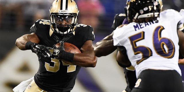 Aug 13, 2015; Baltimore, MD, USA; New Orleans Saints running back Tim Hightower (34) runs with the ball during the third quarter against the Baltimore Ravens in a preseason NFL football game at M&T Bank Stadium. Mandatory Credit: Tommy Gilligan-USA TODAY Sports