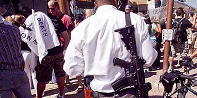 Aug. 17: A man carries a military style AR-15 rifle during an Obama opposition rally in Phoenix.