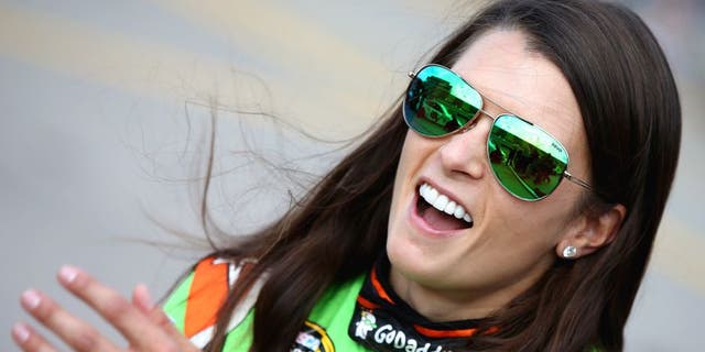 Danica Patrick, driver of the #10 GoDaddy Chevrolet, stands on the grid during qualifying for the NASCAR Sprint Cup Series Pure Michigan 400 at Michigan International Speedway on August 14, 2015 in Brooklyn, Michigan. (Photo by Sean Gardner/NASCAR via Getty Images)
