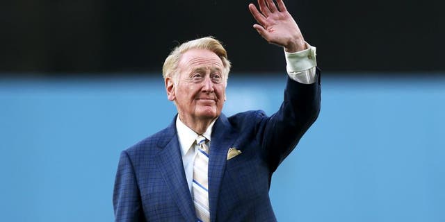 LOS ANGELES, CA - AUGUST 30: Dodger broadcaster Vin Scully waves to the crowd before throwing out the first pitch during ceeremoniew honoring him on his 64 years of sevice before the game between the Arizona Diamondbacks and the Los Angeles Dodgers on August 30, 2012 at Dodger Stadium in Los Angeles, California. (Photo by Stephen Dunn/Getty Images)